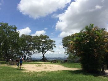 Man on golf course against sky