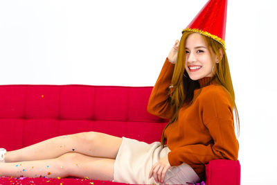 Portrait of a smiling young woman sitting outdoors