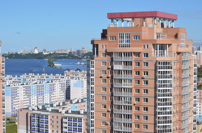 Buildings in city against blue sky