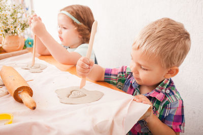 Children making design on clay at home