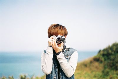 Portrait of man holding camera