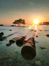 Scenic view of lake against sky during sunset