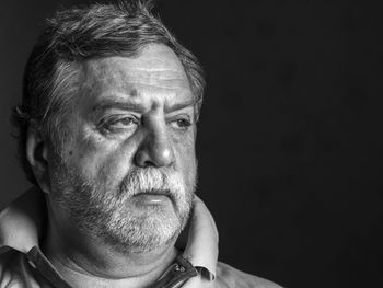 Close-up of man on black background