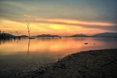 Scenic view of lake against sky during sunset