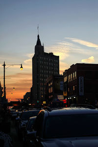 Buildings in city at sunset