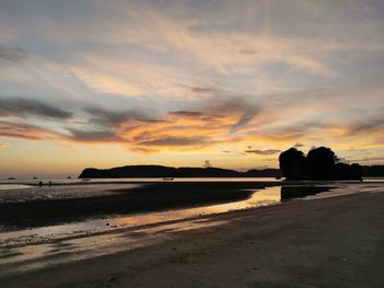 Scenic view of beach against sky during sunset