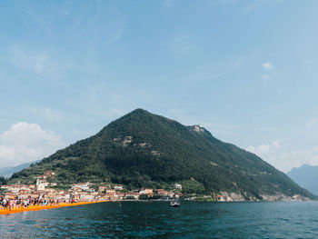 Scenic view of sea and mountains against sky