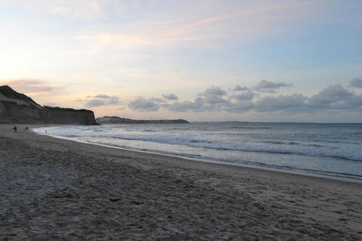 Scenic view of beach against sky during sunset