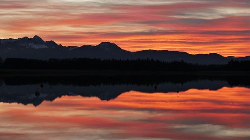 Scenic view of lake against romantic sky at sunset