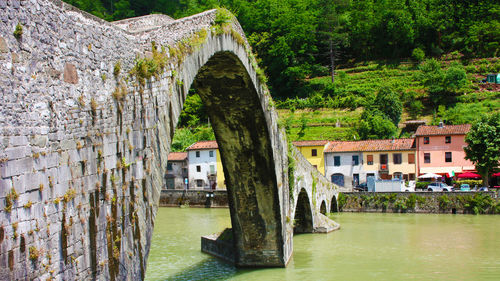 The devil's bridge in the tuscan town of borgo a mozzano on the serchio river between the hills