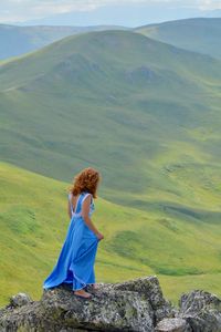 Rear view of woman looking at mountain landscape