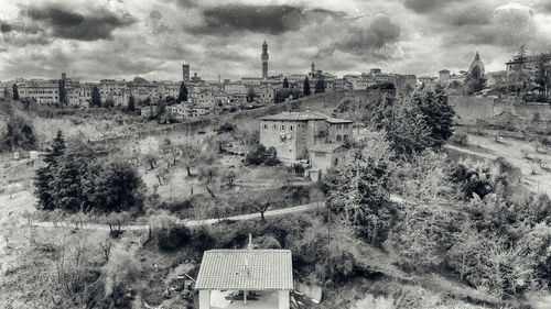 High angle view of old building and trees against sky