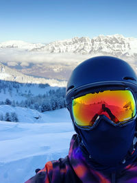 Rear view of man skiing on snow covered landscape