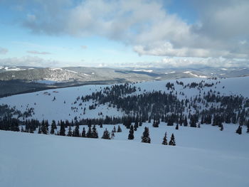 Scenic view of snow covered mountains against sky