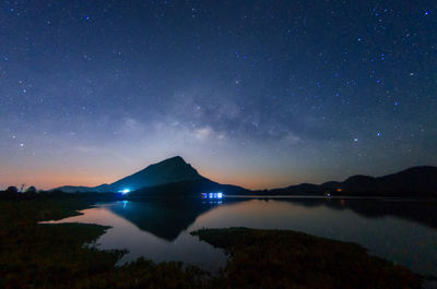 Scenic view of lake against sky at night