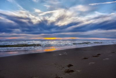 Scenic view of beach against sky during sunset