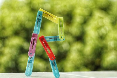 Close-up of letter r made with clothespins on table