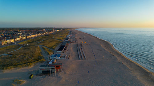 Beautiful flight in summer over the beach in katwijk aan zee. people are resting near the sea.