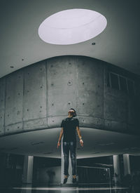 Full length of man standing against wall