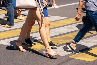 Low section of people walking on road