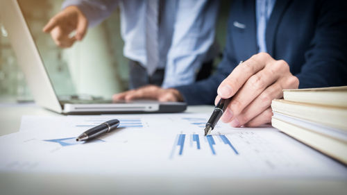 Close-up of man working on paper