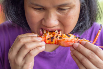 Close-up of woman eating lobster