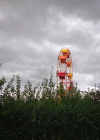 Low angle view of tower and trees against sky