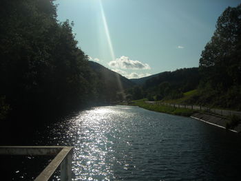 Scenic view of waterfall against sky