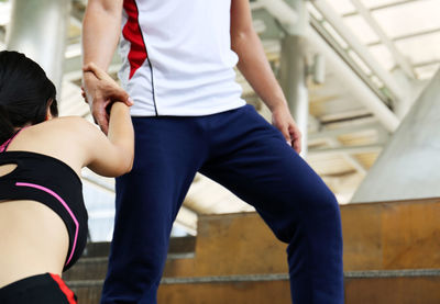 Low section of man and woman standing at home