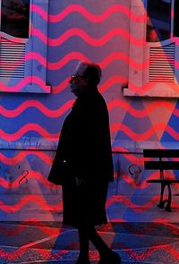 Close-up of woman sitting on wall