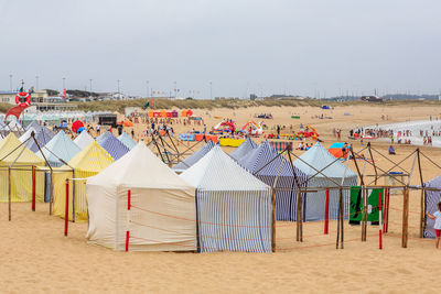 Chairs on beach against clear sky