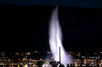Aerial view of illuminated buildings in city at night
