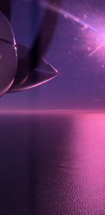 Abstract image of airplane flying over sea at night