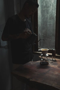 Woman holding coffee cup on table