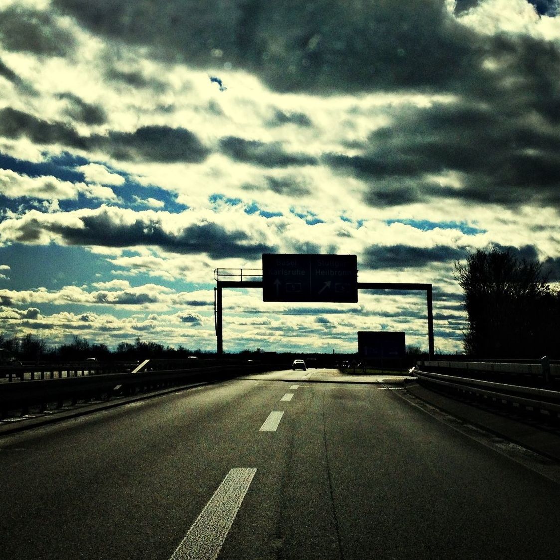 the way forward, sky, road, road marking, cloud - sky, transportation, cloudy, empty, street, cloud, road sign, guidance, asphalt, arrow symbol, diminishing perspective, empty road, communication, country road, vanishing point, tree