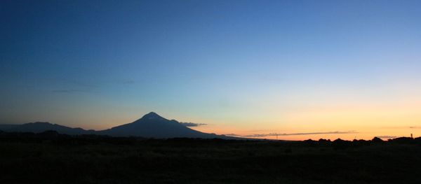 Scenic view of silhouette mountains against sky during sunset