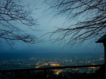 High angle view of illuminated city against sky at dusk