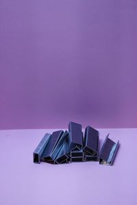 High angle view of empty chairs against pink background