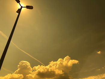 Low angle view of illuminated street light against sky at sunset