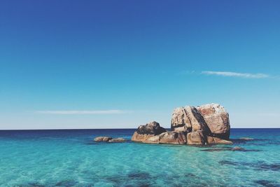 Scenic view of sea against blue sky