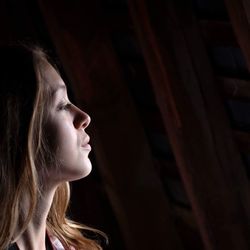 Close-up of young woman looking away at home