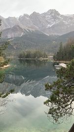 Scenic view of lake and mountains against sky