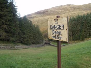 Information sign on grassy field