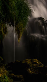 Scenic view of waterfall against sky