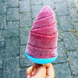 Close-up of hand holding ice cream cone