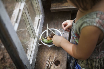 High angle view of girl with bowl at home