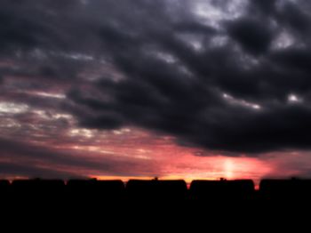 Silhouette of landscape against cloudy sky during sunset