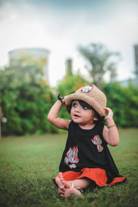 Cute baby girl on field