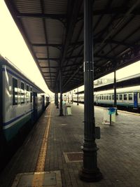 Empty road with columns in background