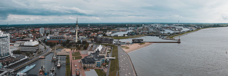 High angle view of buildings by sea against sky